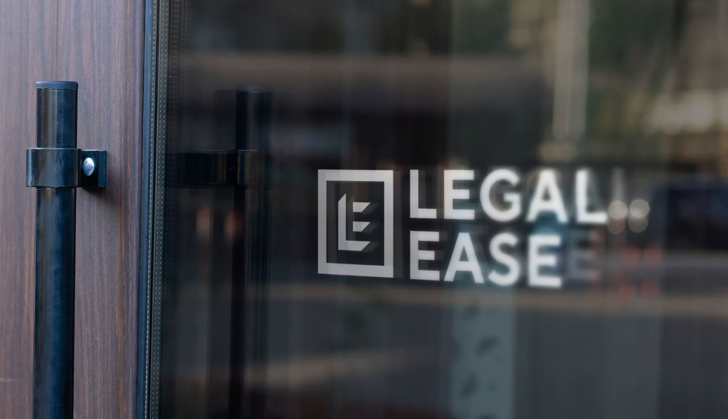 White Legal Ease logo on a glass door