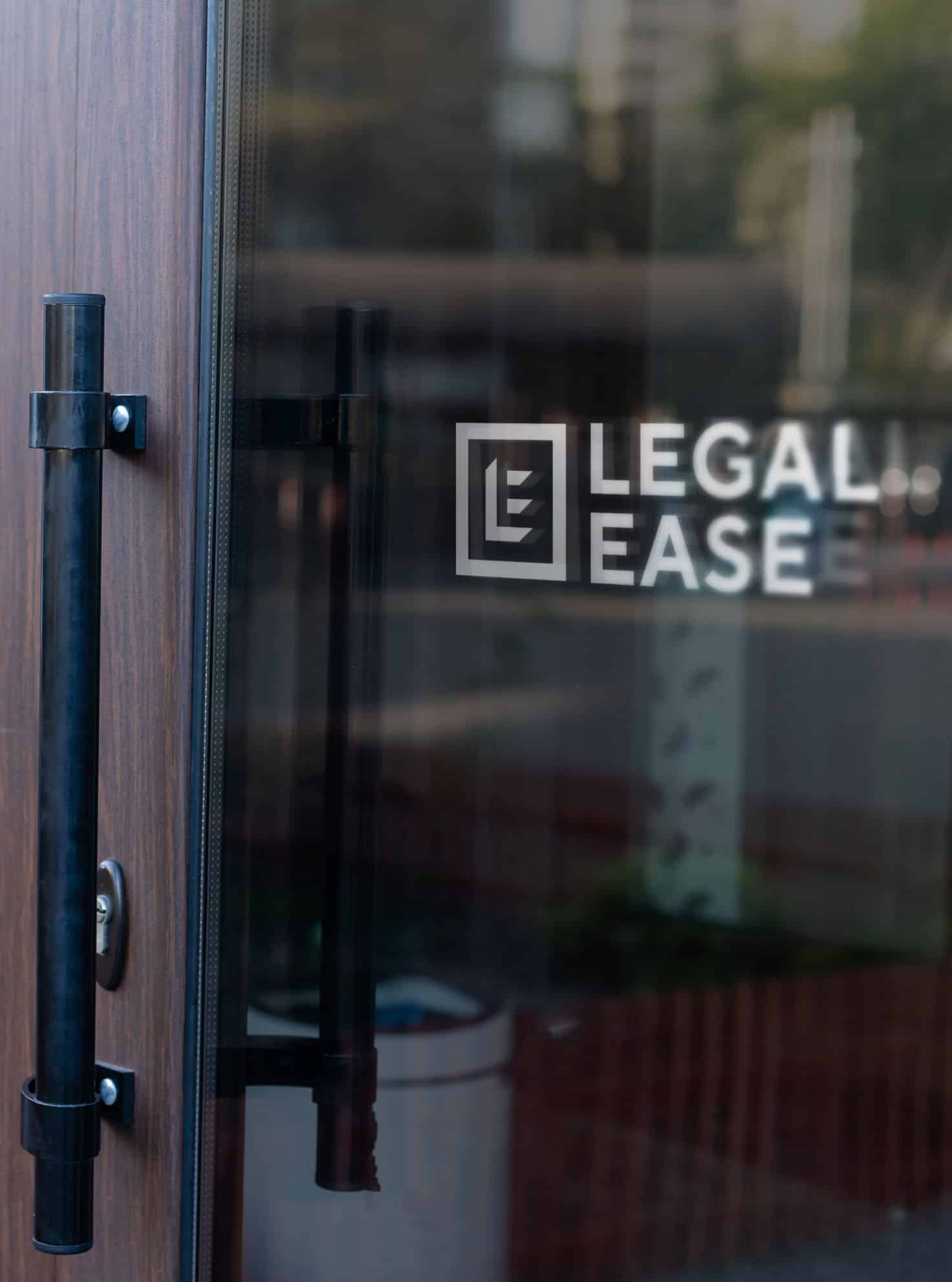 White Legal Ease logo on a glass door